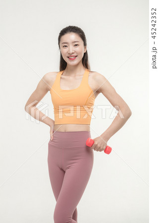 Korean woman exercising with dumbbells Korean woman exercising with dumbbells 45242352