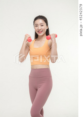 Korean woman exercising with dumbbells Korean woman exercising with dumbbells 45242379