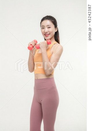 Korean woman exercising with dumbbells Korean woman exercising with dumbbells 45242387