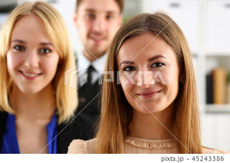 Group of smiling people stand in office looking in camera 45243386