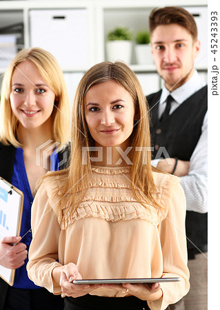 Group of smiling people stand in office looking in camera 45243393