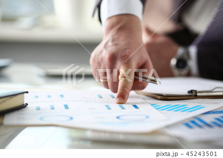 Male arm point finger at important paper on table 45243501