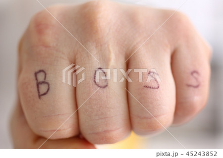 Male clenched fist in suit at office closeup 45243852