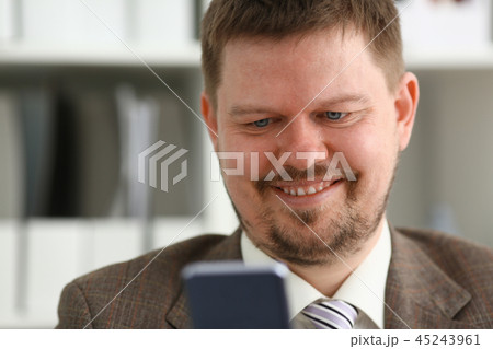 Handsome smiling businessman talk cellphone 45243961