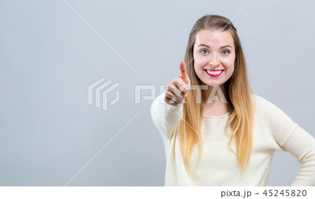 Young woman giving thumb up 45245820
