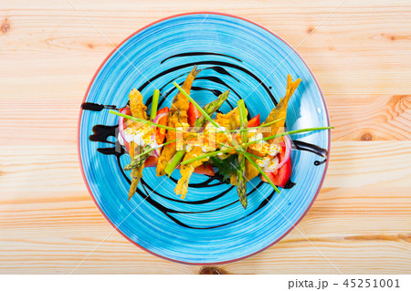 Top view of battered sprats with creamy ginger sauce, tomatoes 45251001