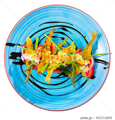 Top view of battered sprats with creamy ginger sauce, tomatoes 45251003