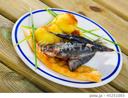 Dish of tasty fried sprats with fried potato croquettes and cake Dish of tasty fried sprats with fried potato croquettes and cake 45251005