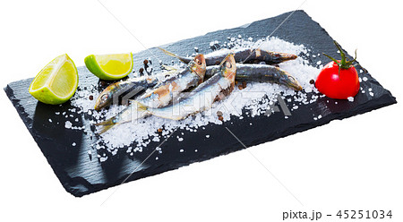 Deliciously dish of anchovy baked in the oven on a pillow of sea salt Deliciously dish of anchovy baked in the oven on a pillow of sea salt 45251034