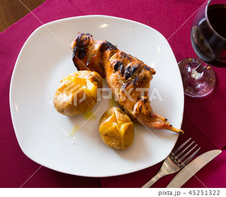 Baked in oven quarter of rabbit, served with pototoes at plate Baked in oven quarter of rabbit, served with pototoes at plate 45251322