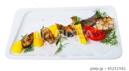 Deliciously baked rainbow trout steaks with potatoes on white plate 45251581