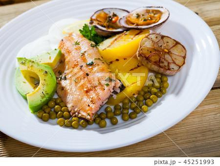 Tasty fried trout fillets, served with seashells, vegetables and avocado Tasty fried trout fillets, served with seashells, vegetables and avocado 45251993
