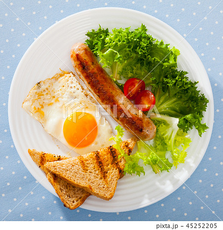 Tasty breakfast of sausage, bacon, scrambled eggs Tasty breakfast of sausage, bacon, scrambled eggs 45252205