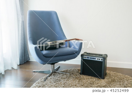 Gray armchair with guitar at corner of living room 45252499
