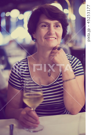 Woman with wine at restaurant Woman with wine at restaurant 45253177