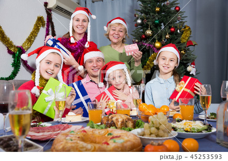 Happy family with kids posing with gifts at Christmas 45253593