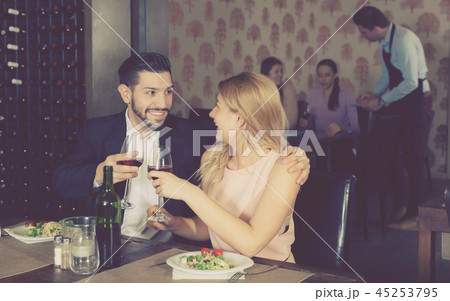 Young couple on romantic date drinking red wine Young couple on romantic date drinking red wine 45253795