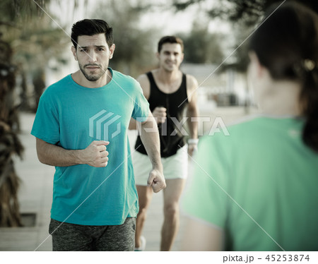 Portrait of adult man who is jogging with friend Portrait of adult man who is jogging with friend 45253874