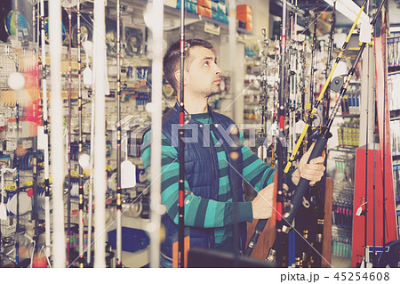 man selecting fishing rod man selecting fishing rod 45254608