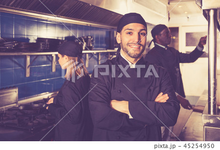 Confident chef in restaurant kitchen Confident chef in restaurant kitchen 45254950