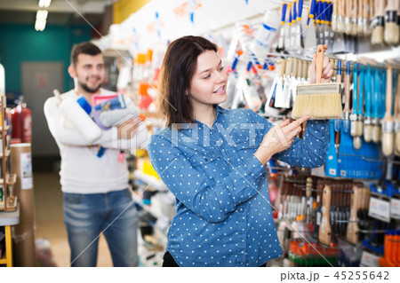 Couple choosing brush for house decoration 45255642