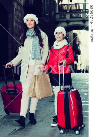 woman with daughter walking with bags woman with daughter walking with bags 45256080