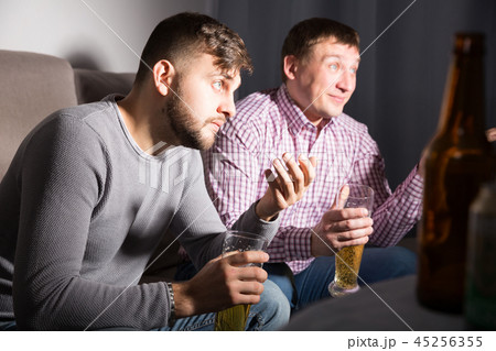 Worried men watching tv 45256355