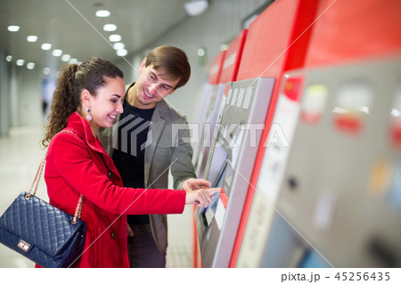 couple purchasing tickets couple purchasing tickets 45256435