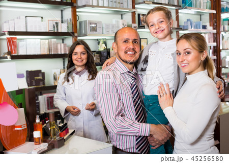 Family with a kid in pharmacy . Family with a kid in pharmacy . 45256580