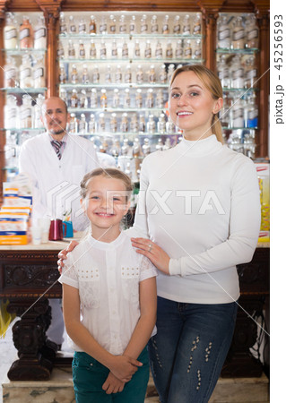 Young mom with a small girl selecting goods Young mom with a small girl selecting goods 45256593