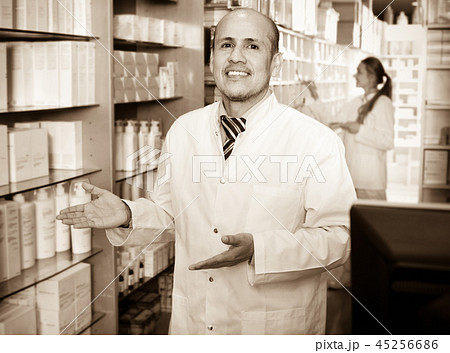 Smiling pharmacist and pharmacy technician posing Smiling pharmacist and pharmacy technician posing 45256686