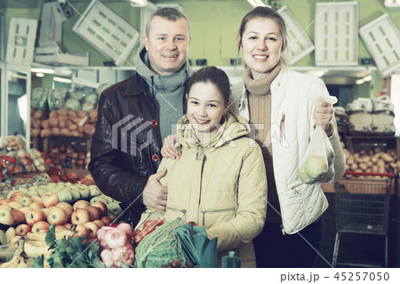 Family with purchases in fruit market Family with purchases in fruit market 45257050