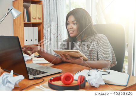 Black businesswoman using tablet and laptop in office 45258820