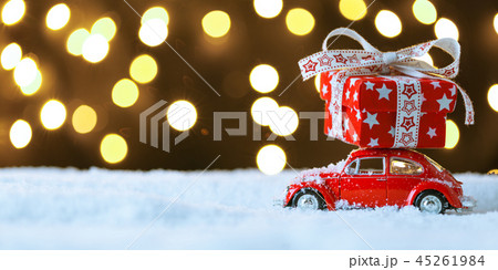 Red retro toy car delivering Christmas or New Year gifts Red retro toy car delivering Christmas or New Year gifts 45261984