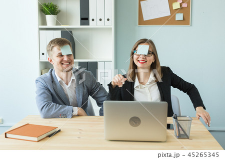 Business, break and people concept - Cheerful man and woman playing games in office while working 45265345