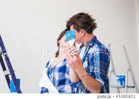 Renovation, repair and relationship concept - Young woman and man hugging each other 45265821