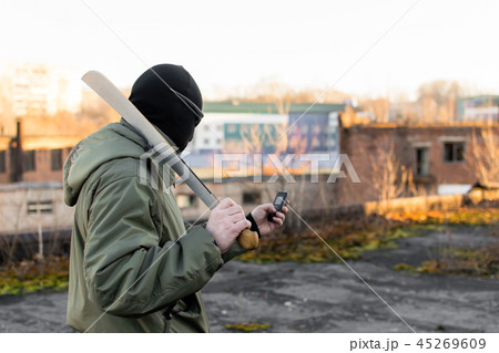 Terrorist with a machete looks into the phone 45269609