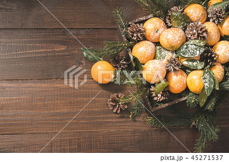 Fresh mandarins with leaves on wooden board. Xmas. 45271537