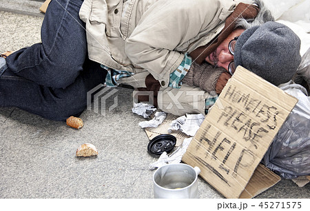 Homeless man sleeping on walking street. 45271575