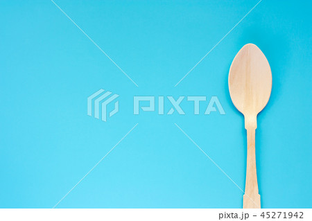 Wooden spoon on blue background Wooden spoon on blue background 45271942
