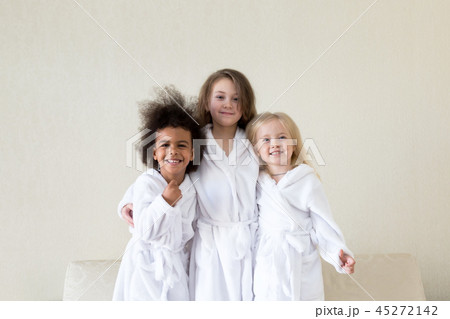 Three funny girls in white coats. 45272142