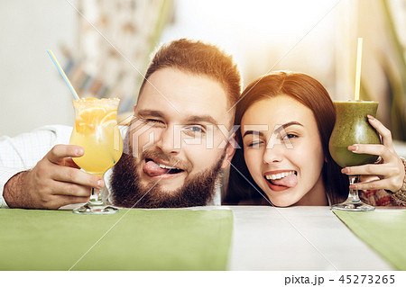 Portrait smiling couple in love drinking cocktails Portrait smiling couple in love drinking cocktails 45273265