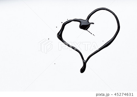 Nail polish on a white background in the form of a black heart 45274631