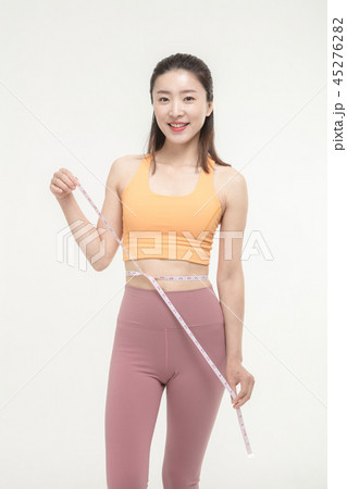 A Korean woman with a waist on a tape measure 45276282