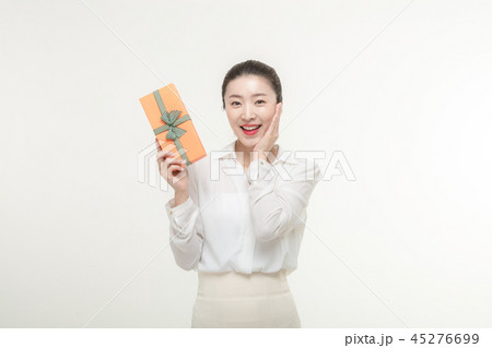 A woman who is delighted to receive a gift 45276699