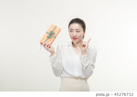A woman who is delighted to receive a gift 45276712