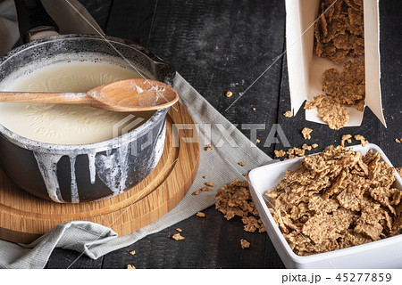 Whole grain cereals and milk in a saucepan Whole grain cereals and milk in a saucepan 45277859