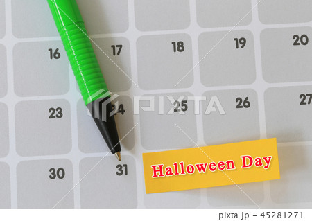 Green pen point to day 31 on calendar paper and have halloween text. Green pen point to day 31 on calendar paper and have halloween text. 45281271