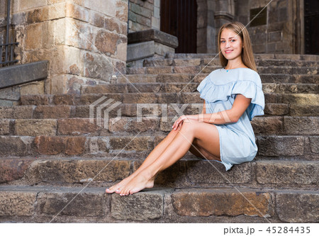 Girl sitting on stairs of temple Girl sitting on stairs of temple 45284435