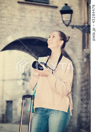 Young girl photographing in the city 45284476